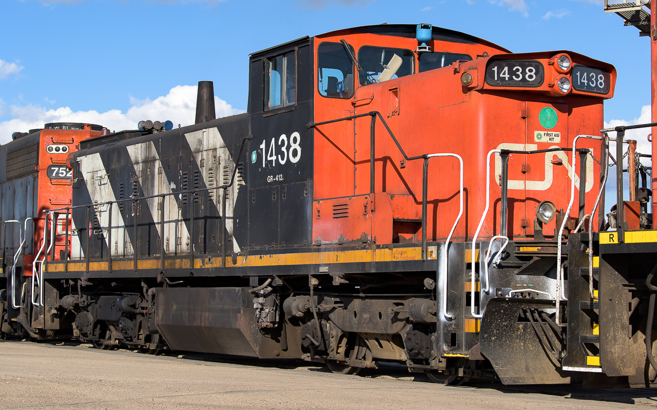 I took advantage of no auto traffic, great sun and close approach to catch a roster shot of the 1438. It was nice finding it out at the CN-CP exchange yard, located by Suncor. The last several times, I have only seen it working the yard at Clover Bar. I have my fingers crossed that at some point it will be freed of the middle unit position.