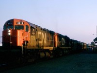 Canadian National's newest name train, the Cabot, was just five weeks into its service life when I photographed it in Drummondville, Quebec, 62 miles east of Montreal on Tuesday, July 4, 1967.  It began on Thursday, June 1, 1967, as a through 966-mile service from Sydney, Nova Scotia via Edmundston, New Brunswick to Montreal, Quebec.   This route was the main route for freight to the Maritimes.  Local services on the line that CN discontinued included a tri-weekly local from Moncton to Edmundston.  They also cut similarly scheduled mixed trains that required an overnight stay at the intermediate division point of Monk if travelling between Edmundston and Joffre, the freight yard near Quebec City. <br> <br>

CN anticipated large travel volumes for Centennial Year events, notably Expo 67, the Worlds Fair in Montreal.  Their new train reduced pressure on the Halifax - Montreal Ocean and Scotian services by offering a speedier, direct service for passengers from Newfoundland and eastern Nova Scotia.  Train 18 left Montreal daily at 6.45 p.m. and arrived in Sydney at 9.15 p.m. the next day, easily connecting with the Newfoundland 'Night Boat' in North Sydney.  In Nova Scotia, CN discontinued the overnight Halifax - Sydney conventional train on May 31, 1967, and added a through Sunday Railiner service.  <br> <br>

The launch also saw the discontinuance of similarly numbered trains 18 and 19, the remnant of the old Maritime Express on the Moncton - Montreal route via Campbellton, New Brunswick.   Local stops between Campbellton and Charny were then served by RDC's on Trains 618 and 619.  On Wednesday, May 31, CN introduced another through coach, sleeping and dining car service to Gaspe on Trains 118 and 119 from a connection with the Montreal - Campbellton, Chaleur, Trains 16 and 17, at Matapedia, Quebec.   At the same time, CN cut off Matapedia - Gaspe RDC's Trains 616 - 617 and except Sunday Mixed Trains 246 - 245. <br> <br>   

The Cabot was a lengthy train.  It included two coaches with reservations required for distances over 160 miles, unreserved coach(es), diner, lounge, coach-lounge, cafe car and four sleepers for the entire run.  An Island series, 8 section 4 bedroom sleeper served Montreal - Edmundston and, an E-series 4 section, 8 duplex roomette, 4 double bedroom car ran between Montreal and Moncton. <br> <br>   

The Cabot featured unusual motive power as CN assigned a pair of MLW C-424s and a steam generator car between Montreal and Moncton.  They had 75 mph gearing, which was appropriate to both flat running and the curvy and hilly former National Transcontinental line through Edmundston.  A pair of RS-18s often provided the power from Moncton to Sydney.  However, the late James Hardie's photographs at Glen Bard show a pair of MLW cab units charging up the grade with 14 cars in tow.  In this picture, MLW built MR-24b 3219 stands ready to depart Drummondville at 8:11 p.m. on the Fourth of July.   MLW delivered 3219 in the summer of 1966.   CN leased many of its 41 C-424s in the U.S. and Mexico.  When MLW purchased 3219 on Tuesday, January 26, 1984, I think that they sold it to the NdeM. <br> <br>   

An indication that the new Cabot was a success came in October 1967 when the premier train, the Ocean, added through Sydney cars at Truro and began to operate via Edmundston.  The following summer season from late June through early September, the Cabot again ran as a through, separate train from Sydney but serving Campbellton while the Ocean continued to run via Edmundston.   This seasonal pattern continued until Wednesday, January 7, 1970, when the Ocean once again travelled via Campbellton.  From then until the end of though cars in late October 1979, the Scotian handled the cars west of Truro. 