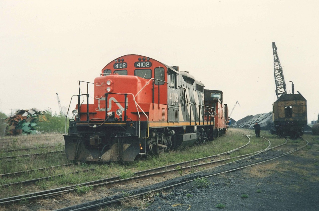 In the summer of 1989 hundreds of car loads of Coal were still coming into Port Colborne via the Humberstone Subdivision, then from CN Nickel back switch to the former Algoma Steel Canadian Furnace Division Yard on the East Side.  The Rochester & Pittsburgh Coal Company would unload and move the cars around with the bucket unit on the right. CN4102 has just picked six (6) empty SANTE FE Coal hoppers and is making the short trip back to CN Nickel.  The entire yard and connection to the former CN Nickel Yard was removed in the mid to late 90's.