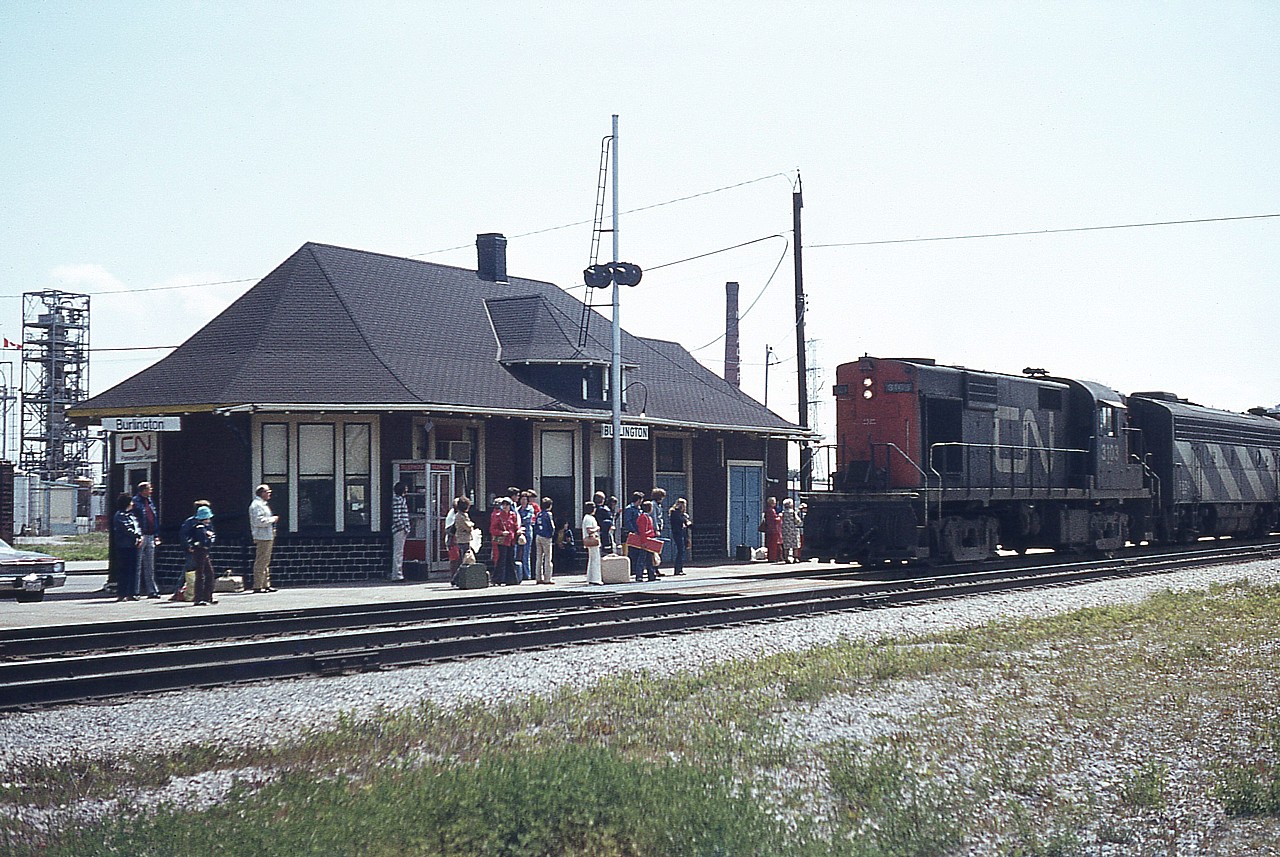 Burlington (Freeman) station was a hard place to shoot when the sun was out. Unless you happened upon the place after 5 PM or so. What is interesting to me about this shot is not so much the power, but the fact there are 2 dozen people hanging around; most to get on, a few perhaps waiting a friend to arrive. Mulroney's chopping of VIA in 1990 plus a host of other anti-VIA changes that were presented to us as "pro"-VIA have pretty well killed scenes like this, save for in a few scattered localities.  Anyway, CN 3103 leads the eastbound in this "pre-VIA" image. This locomotive and the rest of the others in the RS-18 grouping from 3100-3129 were gone from the roster by 1992.