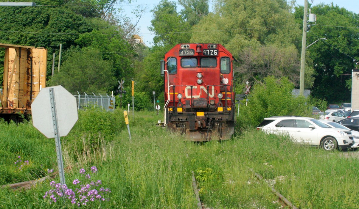 It's doubtful that CN's Fergus Spur will ever seen a weed spraying train. However in this view as bad as the growth is, it would be much worse on the spur here if CN L542 wasn't assigned to it's regular Cambridge outpost. The power for L542, which includes 4726 and GMTX 2274 is viewed spending a quiet afternoon tied down on the Fergus Spur in Cambridge.