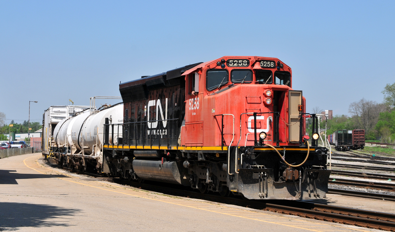 CN 5258 leads their 7 car weed spraying consist through Brantford on a blistering hot May morning