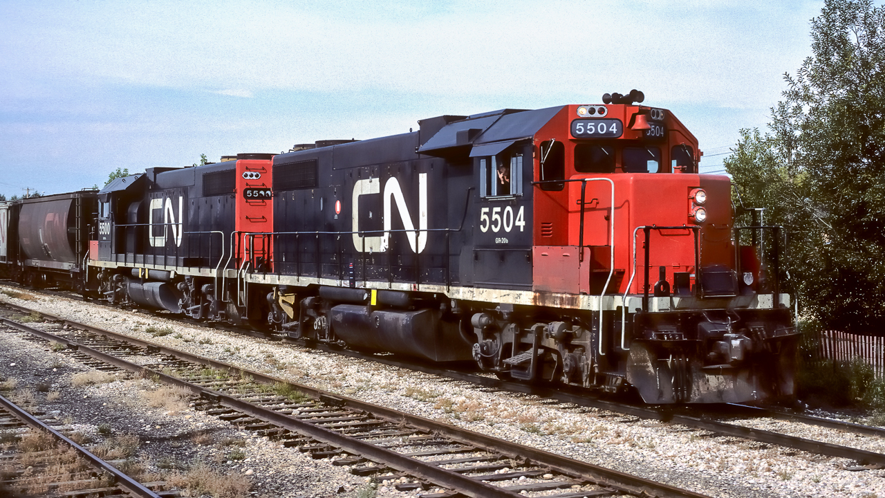 I was looking through fellow contributor Kevin Floods photos and found a good match for a 'then and now' comparison. The subject is the 4704. In my picture, taken during the last week of August, 1986 in downtown Redwater, the 4704 is wearing its original number 5504 and the black CN noodle scheme. It is working the grain train and will be peddling cars from between Gibbons to end of track at Lindbergh. Its companion is the 5500. Both units at this time are 14 years old, having been built in 1972. They show typical signs of wear and tear, rust under the battery box, droopy double 00's in the rear numberboard, paint chips on the longhood etc. A plain set of GP38-2's. I love the early covered hoppers just behind the 5500. In the near future, the 5504 will go for repainting into zebra stripes as I will it photo it in Feb./87 with a new paint job and will be re-numbered 4704 in 1988. In Kevin's photo, taken on March 12th, 2019 (see the comment column for a link to his picture), it appears the 4704 has seen a paint job not to long ago in the past. A number of changes through the 34 years from the Redwater picture are evident. Bell and horns have been moved, flashing light in former bell location, remote control antennas on cab roof, vent on the top of shorthood nose, plus many other smaller changes. The 4704 will be turning 48 this year and should easily make it to the half century mark in 2022. This is quite an accomplishment, it feels like there is a message in there somewhere. It must be a difficult engineering task to build something so it lasts just long enough, but, not to long. Otherwise, build things that last forever and railroad companies don't come back to buy more. I think we have a Pink Energizer Bunny in the GP38, they just keep going and going . . . .