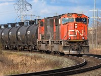 The 5706 and 5731 came off of the Camrose Sub. and took the west leg of the wye at Bretville Jct. After clearing the west switch, they stopped and waited for a signal to shove east through the Jct. and down the Wainwright Sub. In this photo, they are shoving the 25+ empty tanks around the curve that will lead to Clover Bar and a holding track. Shortly, a yard crew will finish the task of delivery to the waiting customer. It was a treat catching these 2 SD75's in good sun.