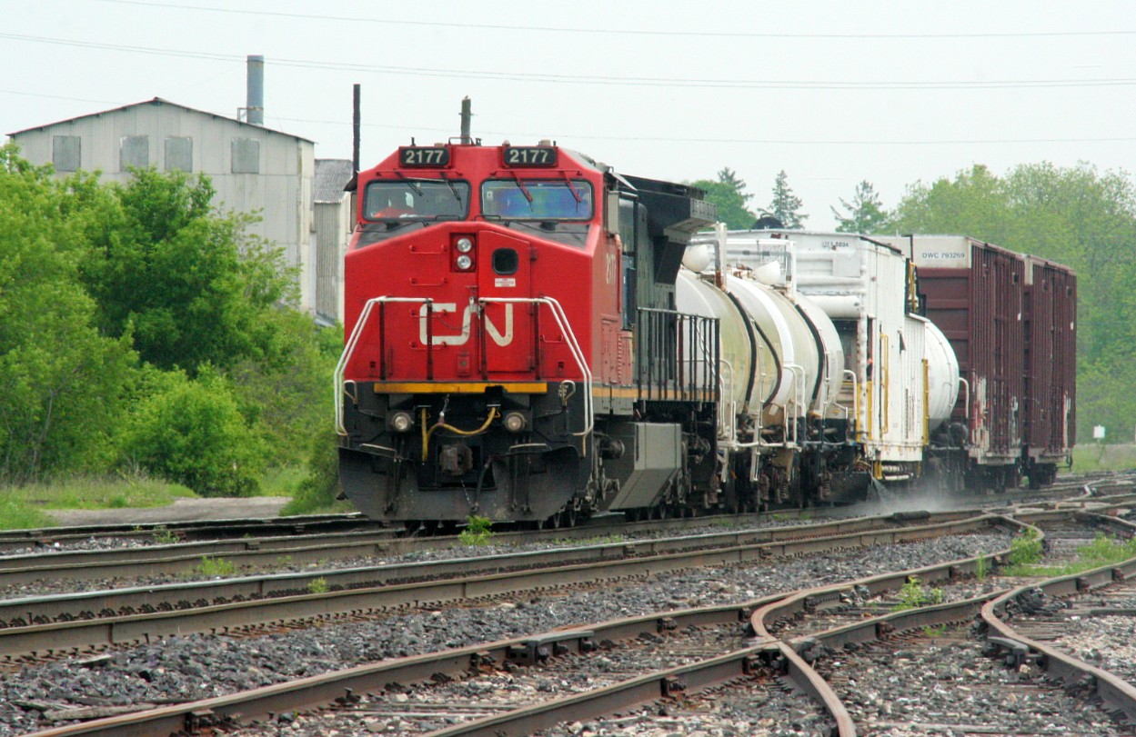 CN 2177 leads 999, the weed spraying train, westbound through Paris Junction on the Dundas Subdivision just before noon. The train is about to meet #72 ahead and 385 was stopped behind preparing to work Paris.