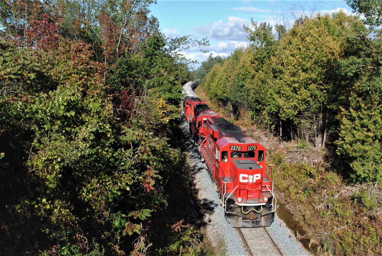CP T07 rolls around the curve and under the road trestle at Tapley, on its slow journey back to Toronto.