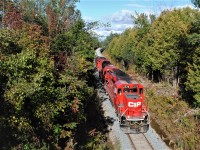 CP T07 rolls around the curve and under the road trestle at Tapley, on its slow journey back to Toronto. 