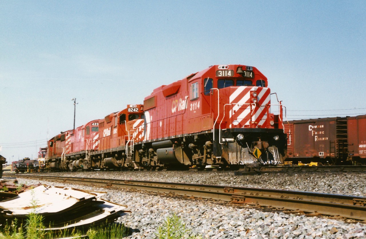 CP GP38-2 3114 is the trailing unit on a motive power set departing the diesel shop tracks at CP's Toronto yard. The power included; GP9u 8242, a C424 and a SD40-2. At the time, according to the Canadian Trackside Guide all of CP's GP38-2's were assigned to Winnipeg and British Columbia, however they were regularly seen operating in Ontario.