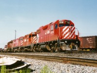 CP GP38-2 3114 is the trailing unit on a motive power set departing the diesel shop tracks at CP's Toronto yard. The power included; GP9u 8242, a C424 and a SD40-2. At the time, according to the Canadian Trackside Guide all of CP's GP38-2's were assigned to Winnipeg and British Columbia, however they were regularly seen operating in Ontario. 