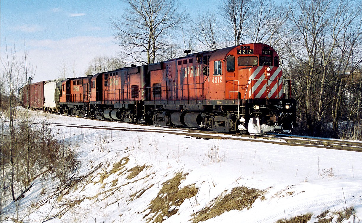 CP's London Pick-Up is viewed switching the industries on the Ayr Pit Spur in Ayr near the Greenfield Road crossing with C424's 4212, 4216 and RS-18u 1813. The train was heading eastbound on the Galt Subdivision towards Galt to lift and set-off cars for Toyota as well as working customers along the way as required.