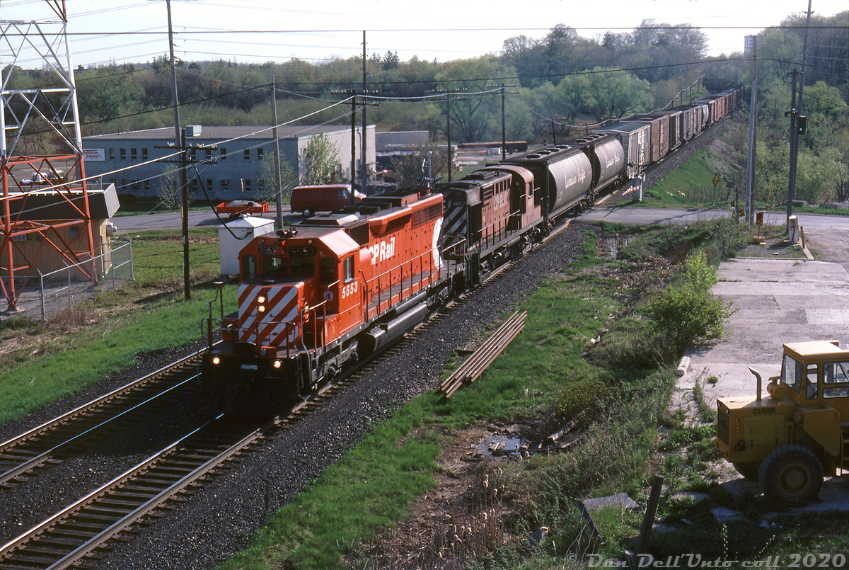 CP SD40 5553 and RS18 1807 lead the London Pickup as it heads west on the Galt Sub through Milton, passing over Bronte Street crossing at the west end of town. Reg's vantage point here was no doubt the CN Halton Sub embankment. Someone at Agincourt Yard must have given the 5553 a good spit and polish cleaning, as it has a nice gleam to it in the morning light.

Reg Button photo, Dan Dell'Unto collection.