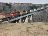 It was during March break from school in 1997 that my dad and I went out for the day around Woodstock and area. The weather was nice and spring was certainly in the air as we waited for a Canadian Pacific westbound to arrive that we heard approaching on the scanner. We waited on the Highway 59 bridge by the west end of Coakley siding. After somewhat of a wait, CP 5655 west curved into view and across the bridge with step-sister SD40-2‘s 5431 and 5428. Prior to being acquired by CP both 5431 and 5428 were former GATX leasers, then prior to that were Union Pacific as they originally were built for Missouri Pacific and obtained through the large UP/MP merger. After getting our photos here, the chase was on towards London for hopefully one more photograph of this colorful westbound. 