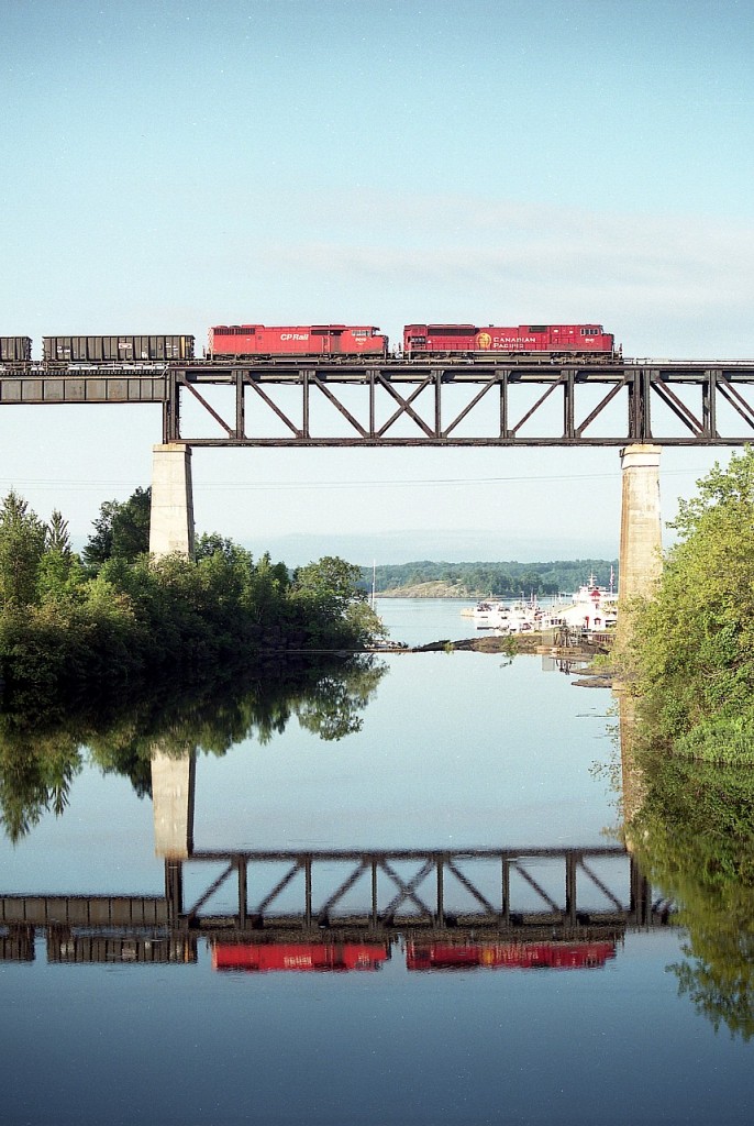 Ah, what a beautiful summer morning!! Northward over the majestic Parry Sound trestle, trailing unit Red Barn 9019 is looking rather diminutive behind that mighty SD90 MAC on the lead.
The 9141 is to undergo upgrades and return to the roster as an SD70ACu in the 7000 series. The Barn went off roster in 2016, dealt to J&L Consulting.