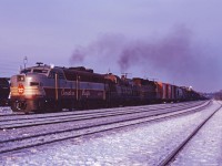 CP FA-2 4042 leads RS-3 8458 and an unidentified GP35 into Guelph Jct with an Extra West, late in the day in March 1970.