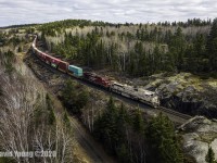 "Army Arid Regions" painted CP 7021 leads the charge out of Kenora, Ontario with Toronto, ON to South Edmonton, AB freight 119-01, navigating the tight curves and undulating grades that were blasted out of the Canadian Shield in northwestern Ontario over a century ago. 