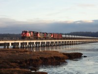 Sunset, tide in, late January 2020. Trio of CN power pulling empty tank cars across Mud Bay on the BNSF North Branch. Took photos from the very south end of Mud Bay Park as the train made it way out of Crescent Beach and continued northbound on the North Branch.