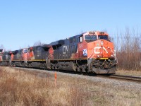 CN train 120 rolls through Sackville, NB on a sunny May day. The lead unit had a pair of Nova Scotia flags mounted on either side of the locomotive