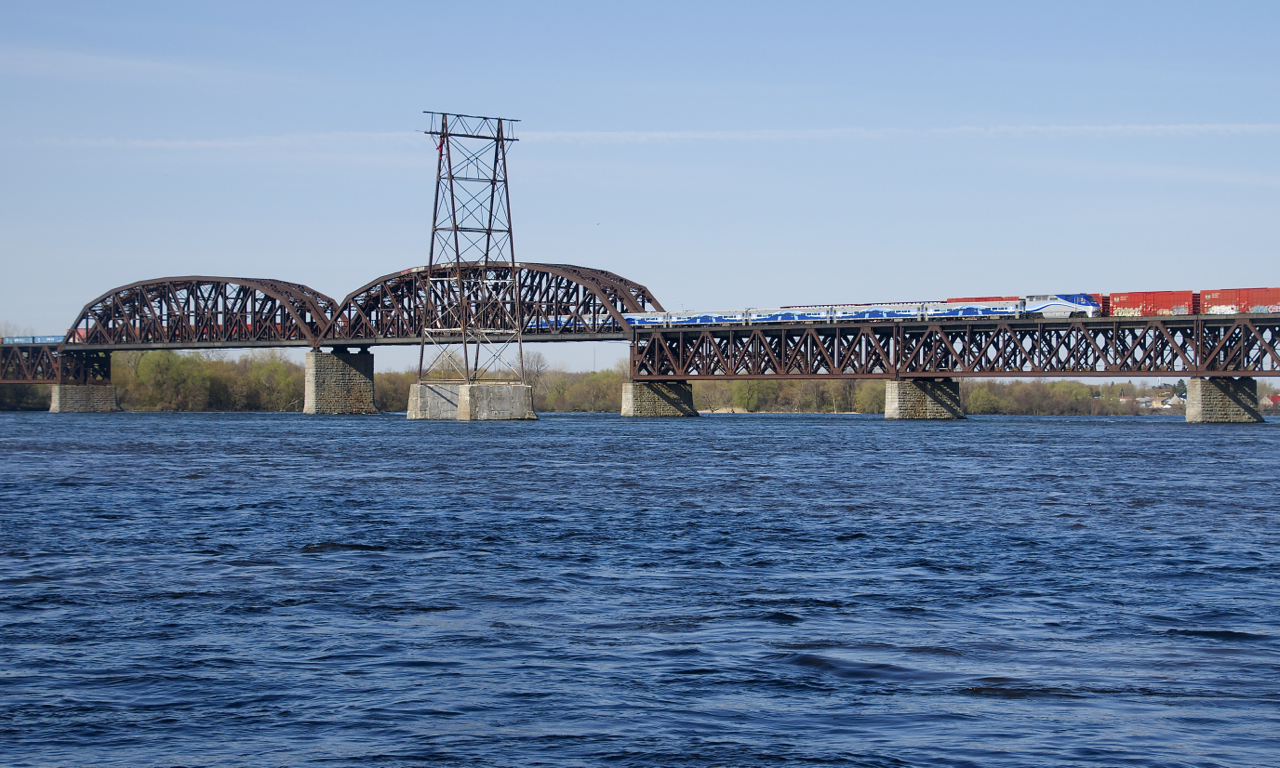 Both CP 253 and EXO 78 are northbound over the St. Lawrence River on a sunny morning.