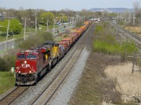 CP 143 with CP 8950 and UP 7042 is westbound on the north track of CP's Vaudreuil Sub with intermodal, mixed freight and then some more intermodal in its consist.