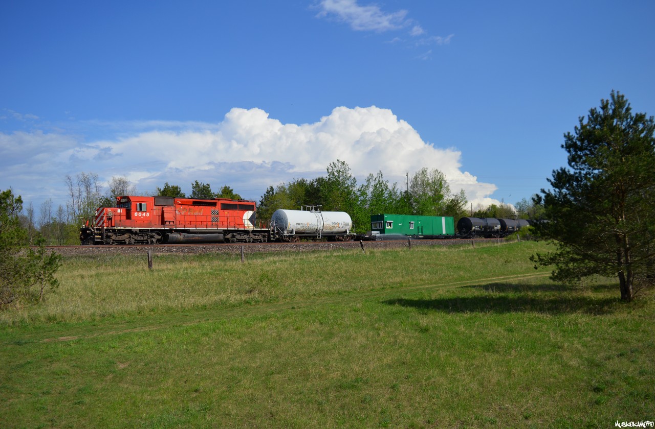 Not far behind or gaining on 113, CP 6045 North with the weedsprayer train slowly makes it's way North on the MacTier sub between thunderstorms at Craighurst.