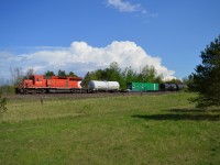 Not far behind or gaining on 113, CP 6045 North with the weedsprayer train slowly makes it's way North on the MacTier sub between thunderstorms at Craighurst. 