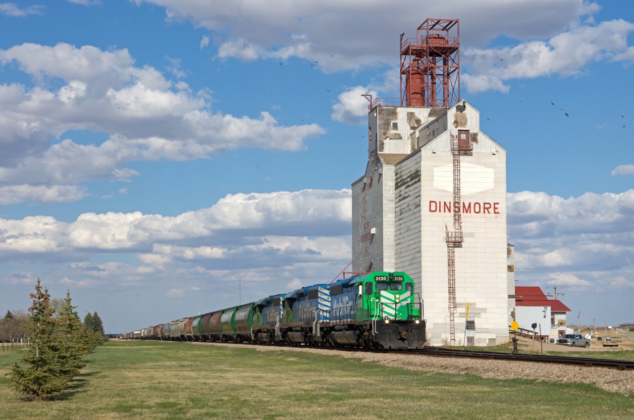 The town of Dinsmore Saskatchewan is named after a land owner to the north who owned the land a post office was built upon in 1907.  In 1913 CNoR built a railway through the area and the post office was moved to the new town site. Today Big Sky Rail, a division of Mobil Grain operates the former CN Elrose Sub. In this scene, three of the railway's finest are seen passing the town's one remaining elevator.