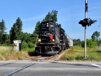 With engineer Steve Bradley pounding the throttle like any other Tuesday or Friday, 0839hrs on the Friday morning of June 29 2018 finds the very last ever regular freight run of the Orangeville Brampton Railway Short Line freight train under ‘CANDO’ making its way past the tiny town of Snelgrove, on approach to the major city of Brampton with 8 empty freight cars in tow from Orangeville Yard. Train is about to cross Mayfield road and if you look towards the end of the covered hoppers on the right you can slightly spot the Snelgrove siding/run-around track which is still used fairly often up to this day by the Trillium Railway (company which operates this short line today).<br> <br> This was the last regular freight train here under CANDO because early in 2018, the CANDO rail company announced to the public that they made the buisness decision to permanently discontinue operations along the 36 mile Owensound Spur for personal company reasons and set June 30 2018 to be their last day of operations here. Word went around Ontario fast and many of us railfans wondered often about the fate of this short line at that time as as it was honestly quite possible for the 36 mile line to fall completely dormant after June 30th depending on how eager the Township of Orangeville was in terms of finding a new Short Line Operator to keep their railway active but lucky for us, they managed to connect with Trillium Railway in May 2018 and to this present day their mp15ac numbered 333 in Blue GATX paint still operates twice a week (mostly Tuesday’s and Fridays still) moving freight from the CPR Galt Sub in Mississauga, 36 miles north to the Township of Orangeville Ontario to service the last 6 customers along the 36miles left of the CPR Owensound Spur who rely of rail: 4 of which are in Orangeville and 2 more in Brampton. <br> * One last Fun fact, from what I’ve heard from locomotive engineer ‘Steve Bradley’ myself, back when he began OBRY operations in 2000 it was still only these exact 6 buisness’s who were using the rail back then. Havnt lost a single customer so far in just about 20 years (but excluding the Brampton Brick Place who Steve himself said he only serviced once very early in his era as by 2000 they had already found that using containers were the most efficient way for them with regards to shipping their bricks across the country by rail, their spur’s switch had been taken out by 2003).