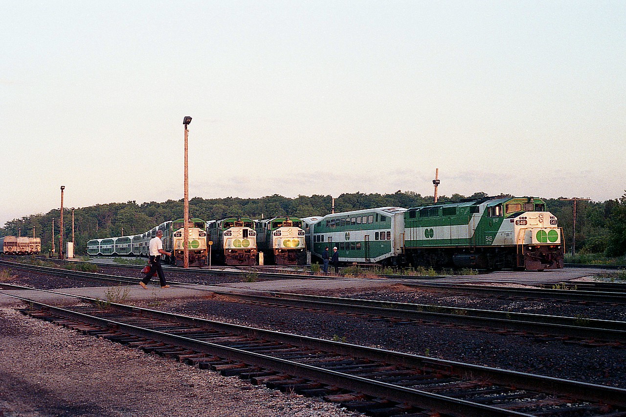 Up early!!!  I made a point of it because only at the longest days of the year could I see in daylight all of the GO commuters as they filed out of the Guelph Jct holding area for the daily run with passengers from Milton to Toronto. I left the house around 0415 to arrive at the Jct approximately 0530. I have not the time recorded for this image but I would guess about 0550. This is the second of 5 out; the first one with GO 528 had just departed and I was not able to get quite enough light for a good photo. Remember, this is back in the film days. So here is the second, 548 the power, and the others are 530, 539 and 541. I believe the west end of these were all cab cars, but have forgotten. :o)
This facility was moved out and east to Milton early 2007.