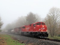 A nice clean SD70ACu rebuild in CP 7037 leads a 5500 foot CP 246 up to Conservation Road in the light rain and fog on its way southward down the Hamilton sub for work at Kinnear Yard. The light rain and fog do a nice job to enhance the bright clean color of the leader.