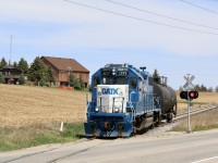 The Fergus spur is just one of those lines that seems to defy the odds. A line that seems like it should have vanished years ago. Somehow it justifies daily service and even has motive power stored on line. It's hard to believe the line once stretched all the way from its namesake town all the way south to Harrisburg, near Brantford. The 1980's claimed over 3/4 of the original trackage, no longer passing it through Fergus as well. Even the one time busy industrial park a branch off the line one served today sits lifeless and is only used east of Highway 24 to access a wye to reposition the daily train and power for the next days trip. Between Guelph and Cambridge there is only one active rail side customer, which local 542 is seen departing from after exchanging a lone take car for another one. Other then that the only online customers in Cambridge are a lumber yard and a wallboard transfer facility in Preston. But for now the line manages to cling to life somehow, with typically one or two units ambling along at a leasurely pace typically arriving in Guelph in the morning hours before working the North spur and yard in town then heading back to Preston to spend the night. In the image here the switch to Flochem is in the background and the farm makes a nice backdrop. After the line crosses highway 24 it will then become unshootable traveling through an old gravel quarry until it's arrival in Hespeler. 
