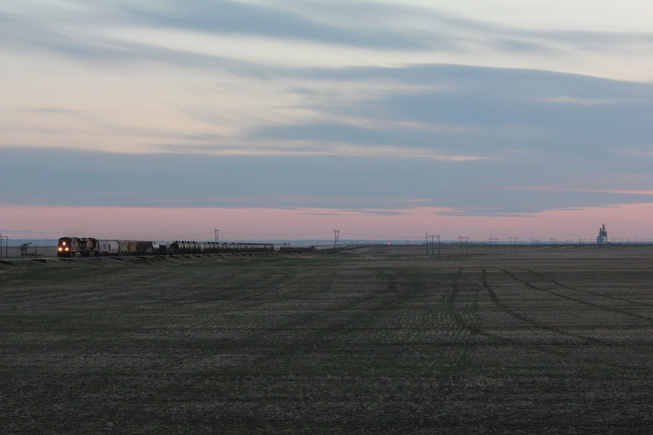 After unsuccessfully heading to Moose Jaw hoping to catch 6644 only to find it hidden on the shop track with its stripes visible, I ended up with some luck. 8810 was starting its journey out of the yard and I knew I could get ahead of it as long as the sun held up long enough. In fading light CP 8810 helds east out of Pasqua where it will  be held in Belle Plaine before continuing on to further points east.