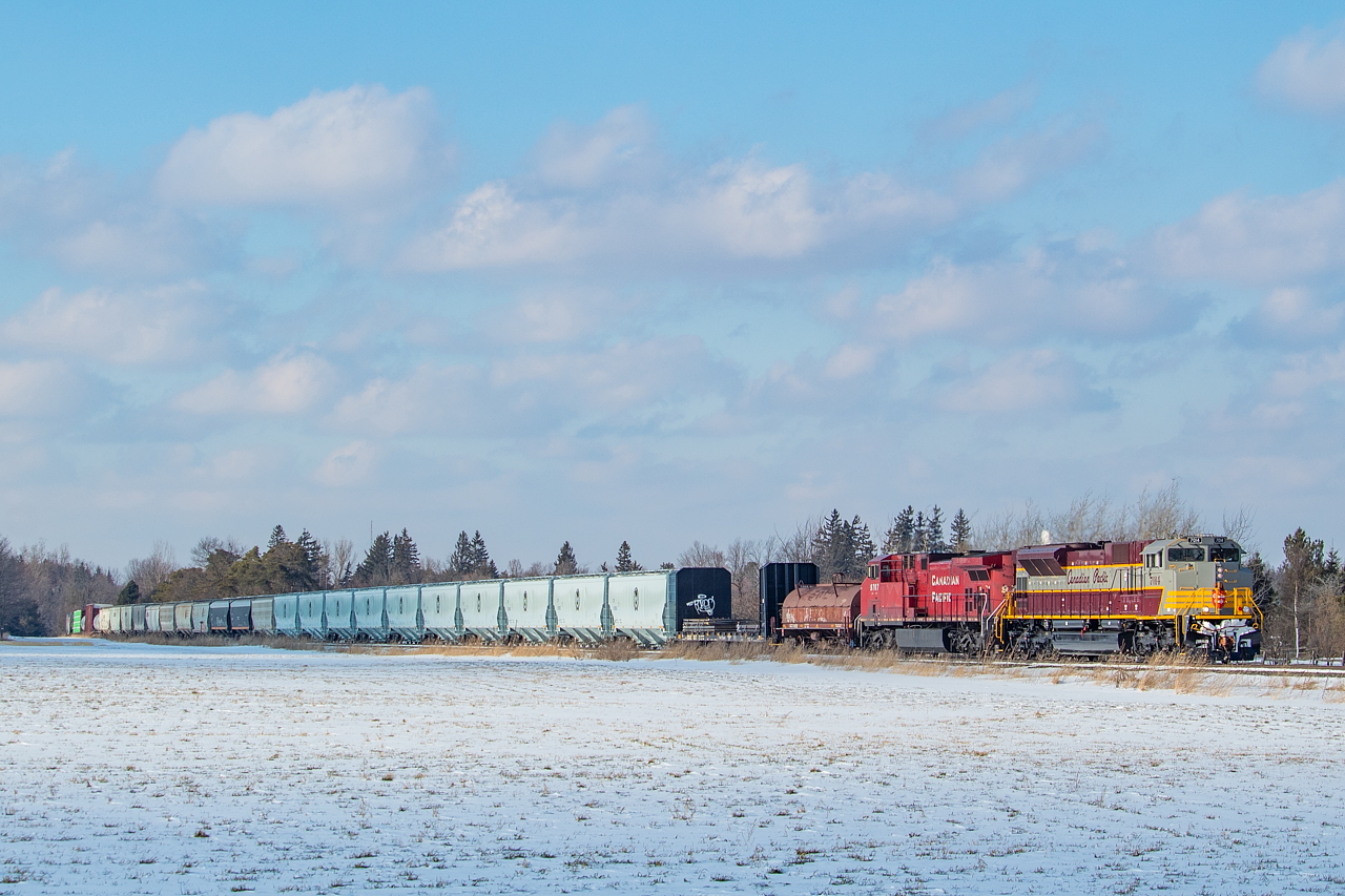 A highly chased 246 heads southbound towards Hamilton as it dodges clouds. The head end 12 cars were a Hamilton set off - with the loaded coil for Aberdeen, the loaded bulkhead for interchange with CN to be taken to Empire Steel on the Grimsby, and the 10 new CP grain hoppers for Richardson in the Eastport area. The other grain hoppers were a Welland set off for interchange with Trillium to be taken to Port Colborne.