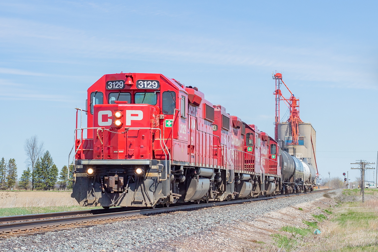 T29 blasts through Glencoe, doing all of 60 miles per hour, with a three pack of GP38-2s (3130 and 3119 being the other two) and four tanks for the ethanol plant in Chatham. They'd return to London a couple of hours later with five tanks in tow.