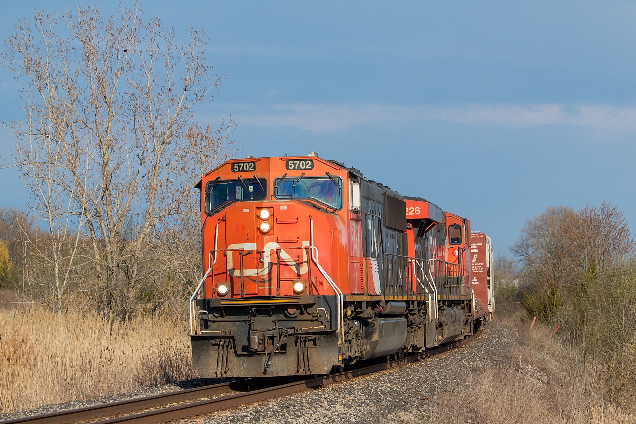 CN L561, with the 5702 on point, leans into the curve heading towards CN Yager that will take it from predominantly westbound travel to northbound travel as it heads to Port Robinson with traffic lifted from the BPRR in Buffalo and traffic lifted from the NS in Fort Erie. It had recently poured in Fort Erie, and the heavy presence of clouds is still seen to the east. 531 normally handles this work, however, for the time being, 531 is cancelled. Interestingly, the Port Rob to Buffalo runs (531 and 539) are usually an odd number, and the return an even number (530 and 538). But, with 562 now doing 531's job for the time being, it is the opposite with an even number from Port Rob to Buffalo (562) and an odd number on the return trip (561).