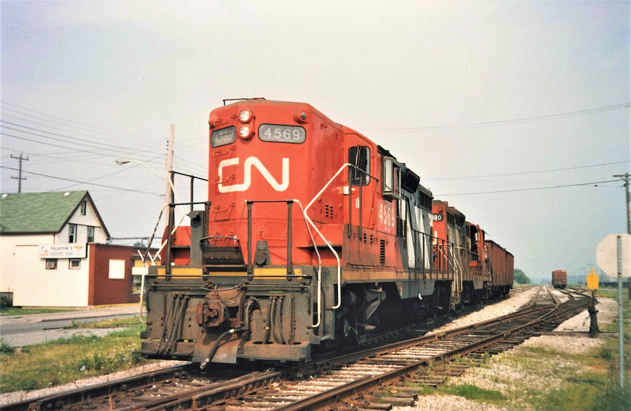 At the west end of Nickel, CN 4590 and 4569 roll past with a pair of Sante Fe Coal Hoppers fresh from the Rochester & Pittsburgh Coal Yard where they were off loaded.  4569 and GP9's of this era in high nose configuration never failed to please.  With the GP9RM conversion program well underway,  this all too common site soon disappeared.