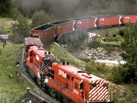 Eastbound Trail to Calgary freight 984 on the lower loop on the climb to Crowsnest Summit. Current timetable shows location as Fabro and a line continues up the valley on the upper left to Byron Creek coal mine.