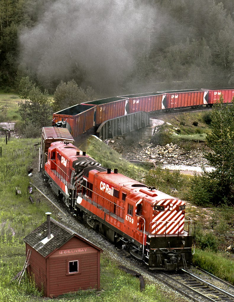 Eastbound Trail to Calgary freight 984 on the lower loop on the climb to Crowsnest Summit. Current timetable shows location as Fabro and a line continues up the valley on the upper left to Byron Creek coal mine.