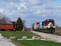 One of the last of Ontario Southland's movements is seen here heading East passing what would have been the signal for Yarmouth diamond with the Canada Southern. 