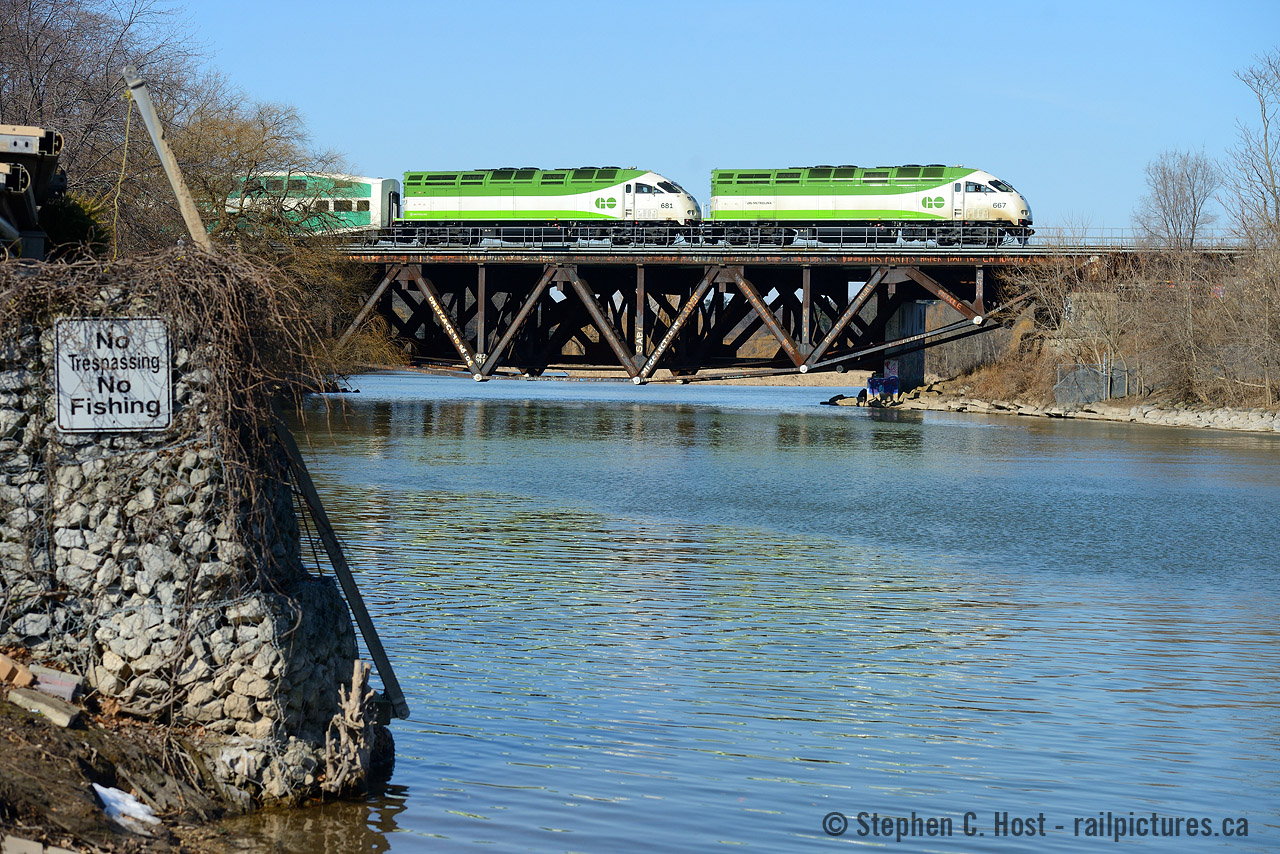 A matched pair of Tier 4, Cummins powered MP54AC's charge this eastbound GO train on the Lakeshore Line (MX Oakville Sub) across the reverse truss bridge at Port Credit that has fascinated me. It's certainly been there a long time and surprisingly untouched after all the infrastructure upgrades by Metrolinx! See these photos by Bill Thomson such as This in 1964 or this shot of a train that fits on it in 1981. I bet some of the same Graffiti is still on it.
