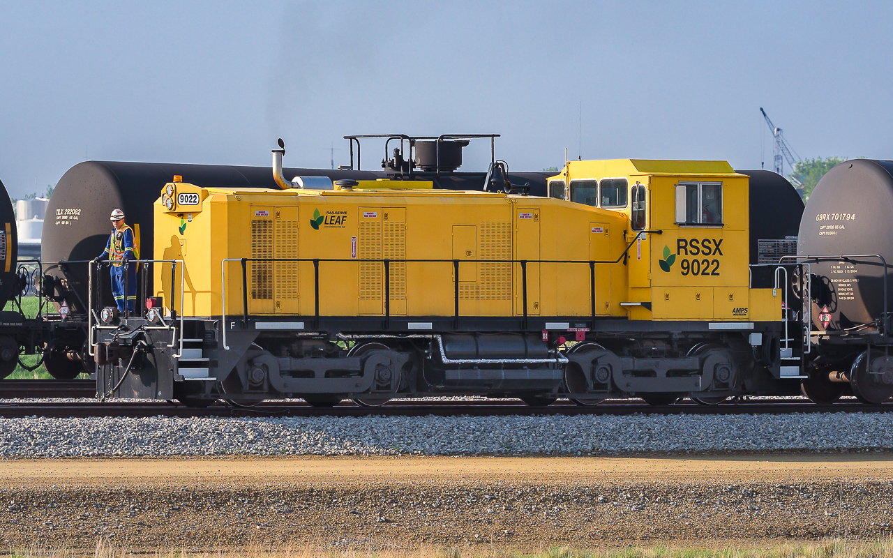 Of the numerous times that I have passed by Kinder Morgan, this is the one instance where their switcher was off the shop track and in a place where taking a photo had no obstructions in the way. The fence being the worst for getting in the picture. Only a handful of times have I seen the 9022 started up and making a move. On this day it is pulling a small string of tanks, 10 or so, and working hard at the task. I cannot imagine when or how extra cars become available. The unit trains sure do seem to remain intact during their stay at the loading facility. RSSX 9022 is a former SW9, it appears that it went for rebuilding sometime in 2014. There are several internet pictures from 2015 showing it in transit to Edmonton. As already mentioned, it has spent most of those 5 years sitting out in the back 40, not the best second life scenario.
