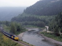 MLW on a Misty Matapedia Morning <br> <br>

Via Train 16, the Chaleur is beyond Routhierville, Quebec and is nearing Glen Emma, Mileage 28.69 of CN's Mont Joli Subdivision.  Running alongside the Matapedia River, a world-class salmon fishing stream, the train will turn east at Matapedia, Mileage 12.81.  It's 9 a.m. Sunday, August 28, 1983, and the Chaleur is nine and a half hours into its almost 17-hour, 654-mile run from Montreal to Gaspe. <br> <br> 

The Intercolonial Railway completed the rails through the scenic Matapedia Valley on July 1, 1876, finishing the link between Nova Scotia and New Brunswick to Quebec and beyond to Ontario.  The railway was one of the terms of confederation that brought these first four colonies together to form the new Canada on July 1, 1867. <br> <br>

CNR 6760 (10-1958 #82269) was the first of 34 A and 12 B units in a new model, the FPA/B-18 introduced by MLW in 1958.  Fortunately, MLW underbid GMDL's offer for additional FP9s by a mere $500 per unit to secure the order in July 1958.  MLW delivered the A units in two subclasses MPA-18a and 18b, between October 1958 and May 1959.  Each locomotive featured MLW's 12-cylinder 251 series diesel producing 1,800 horsepower, GE-752 traction motors and a GT-581 main generator.  They had a long service life, notably in Eastern Canada, lasting for the most part until March 1989 when they did not receive the federally mandated Reset Safety Control feature.  By this time, the arrival of 59 GMDL F40-PH2s and pending massive service cuts rendered them redundant.  Sixteen of the FPA-4s and five FPB-4s went on to Canadian and American museums or second careers on tourist lines in the U.S.A.   VIA acquired 6760 from CN in March 1978, and ten years later, it went to the Napa Valley Wine Train as their 70.<br> <br> 

The train's consist included baggage dormitory 9480, which had 14 of its 22 roomettes remaining after its rebuilding in 1973.  CNR had acquired NYC's former Delaware Bay (Budd 8-1948) in January 1959 and renamed it Valpoy.  Greenwood (P-S 1954) a 6 section, 6 roomette, 4 dbl bedroom sleeper, Dayniter 5711 converted from CC&F 1954-built coach 5484 in 1973, coach-cafe-lounge 759 formerly the 3020 built as coach 5451 and coaches 5584 and 5652.