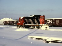 The sun is just above the horizon in this winter view of GMD GP9 CN 4537 in Allandale Yard.<br>
Lake effect snow off Georgian Bay / Lake Huron is common in Barrie winters.<br><br>
The removal of Newmarket Sub tracks between Allandale and Longford (beyond Orillia) in 1996 greatly reduced rail traffic through this former CN hub; VIA's Canadian and ONR Northlander were re-routed to the Bala Sub.