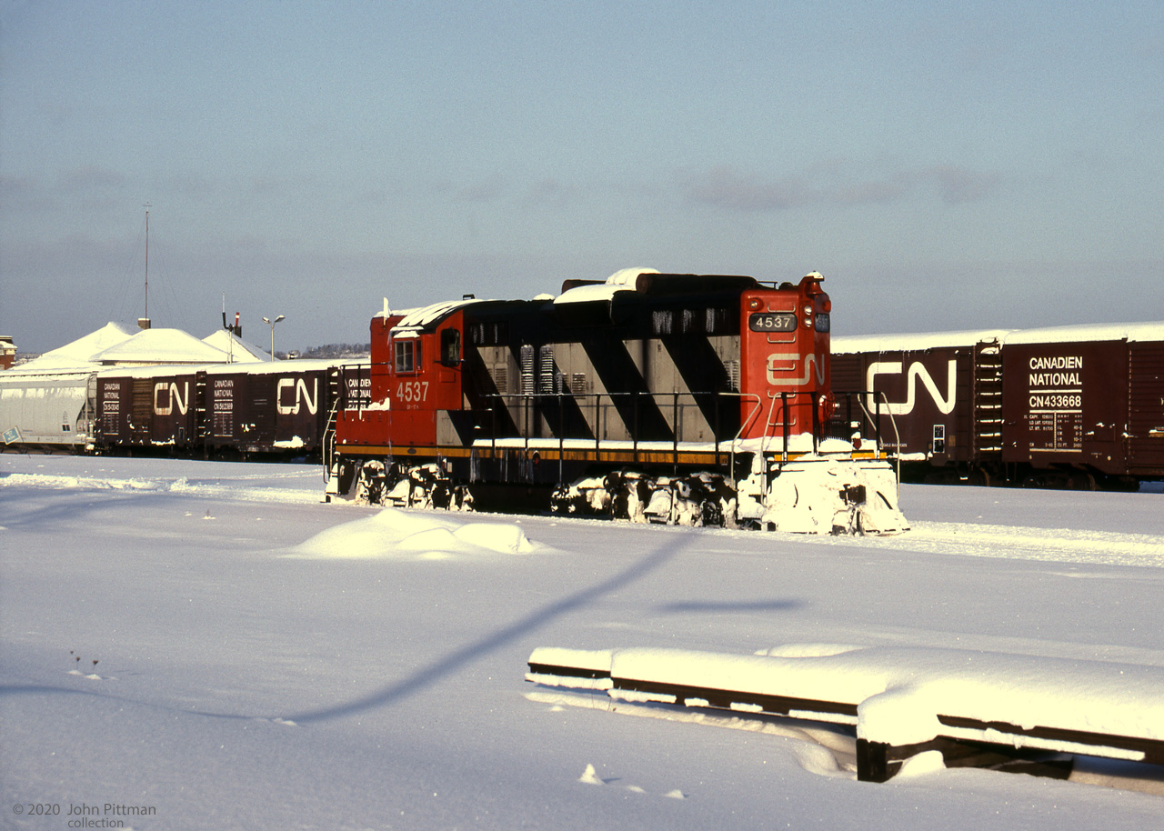 The sun is just above the horizon in this winter view of GMD GP9 CN 4537 in Allandale Yard.
Lake effect snow off Georgian Bay / Lake Huron is common in Barrie winters.
The removal of Newmarket Sub tracks between Allandale and Longford (beyond Orillia) in 1996 greatly reduced rail traffic through this former CN hub; VIA's Canadian and ONR Northlander were re-routed to the Bala Sub.