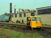 A couple of CP guys are riding speeder 27 0301 on secondary track close to Galt Sub signal 113.7<br><br>Location has been mapped to Adelaide St at the west end of Quebec Street yard.<br>If that is right, the industrial buildings have since been demolished, replaced by a Self-Storage facility.