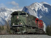 Wearing "Army Temperate Regions" green, CP SD70ACU 7020 leans into a curve just east of Canmore leading 303-608's grain loads west on the Laggan Sub. 