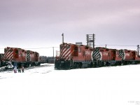 A quiet winter Saturday in a CP yard in Red Deer, Alberta over 40 years ago.<br>
Five similar uncut GP9's were resting in the yard: CP 8812, 8818, 8833 plus CP 8836 and another (8539?).<br>
Seems to me the unknown photographer was pushing his luck, bringing along spouse, children, and pet dog (good that it's on a leash).<br> Hopefully he had permission to be there - nowadays not tolerated.<br><br>
A yard at the edge of Red Deer on the CP line to South Edmonton has been mapped, may not be exact.

 