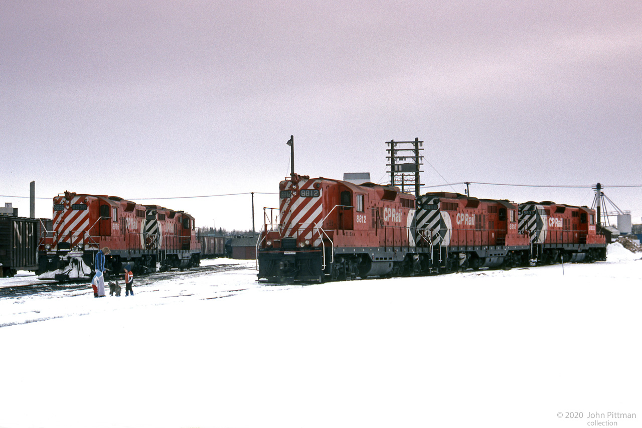 A quiet winter Saturday in a CP yard in Red Deer, Alberta over 40 years ago.
Five similar uncut GP9's were resting in the yard: CP 8812, 8818, 8833 plus CP 8836 and another (8539?).
Seems to me the unknown photographer was pushing his luck, bringing along spouse, children, and pet dog (good that it's on a leash). Hopefully he had permission to be there - nowadays not tolerated.
A yard at the edge of Red Deer on the CP line to South Edmonton has been mapped, may not be exact.