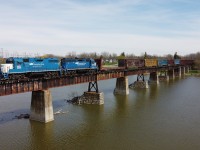 CN L580 crosses the Grand River in Caledonia with a long string of bulkhead flatcars for CGC in Hagersville.  Power on this day if the GMTX 2255 and GMTX 2695