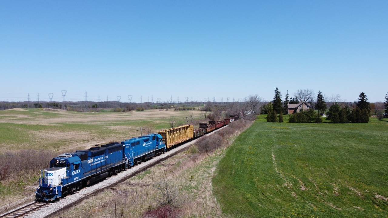 CN L580 makes their way through the Brant County countryside as they approach the Brant 22 Road crossing with a large train.  Following the tie program on the Hagersville Subdivision, 6 gondolas were used to load up the scrap ties in Caledonia and were tagging along on the front of the train on this day.
