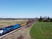 CN L580 makes their way through the Brant County countryside as they approach the Brant 22 Road crossing with a large train.  Following the tie program on the Hagersville Subdivision, 6 gondolas were used to load up the scrap ties in Caledonia and were tagging along on the front of the train on this day.